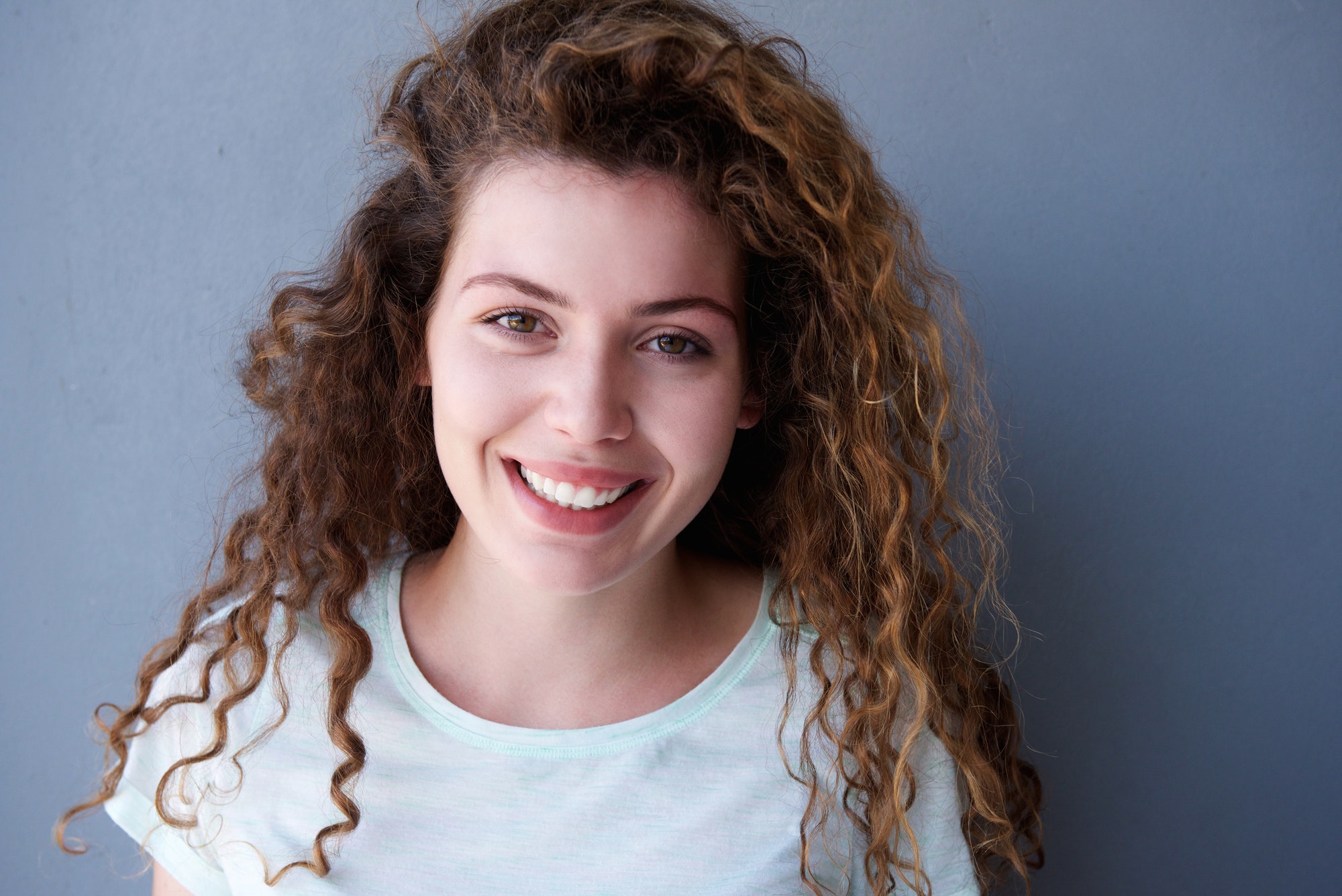 Happy and healthy teen girl with curly hair