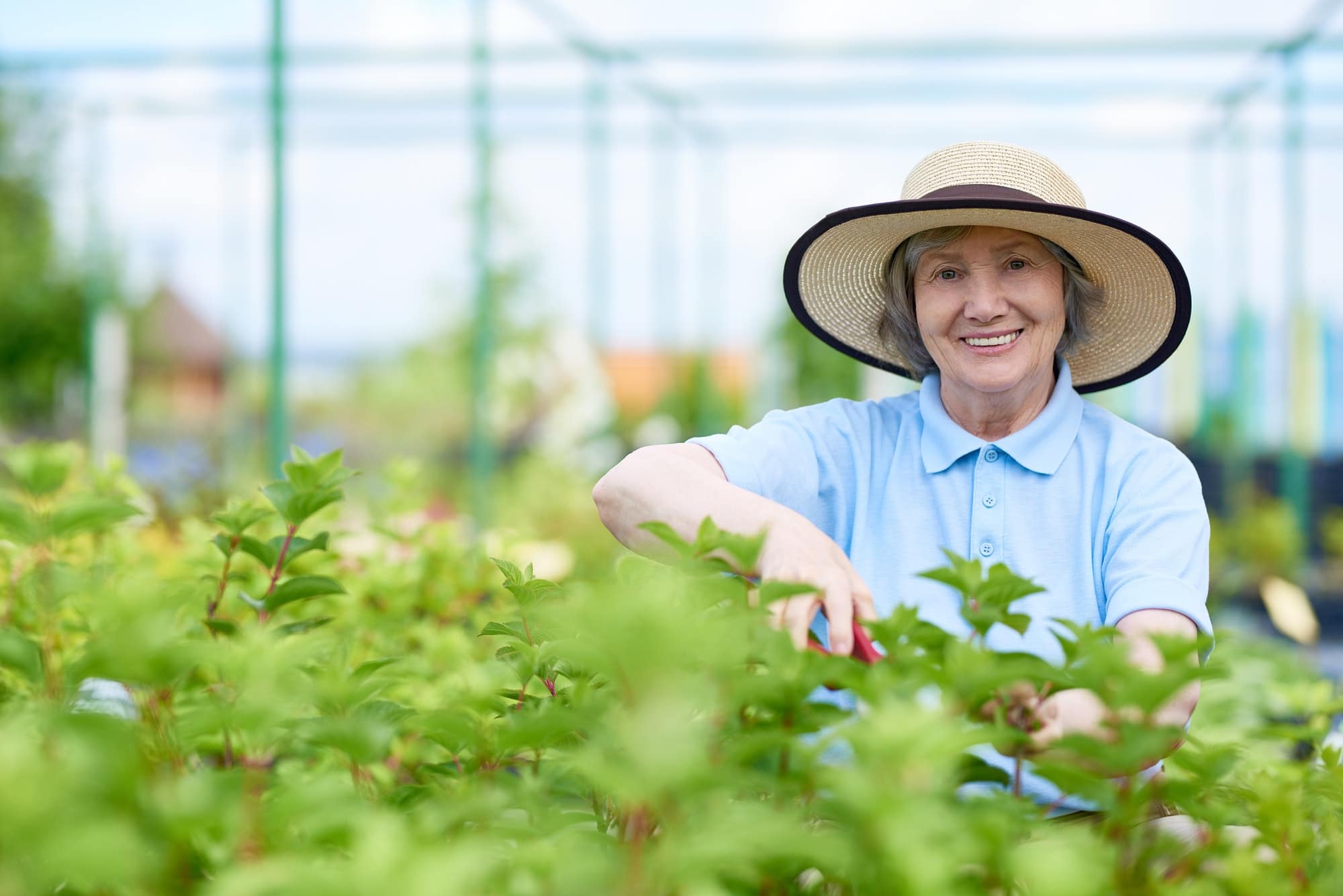Happy Senior Woman Enjoying Work in Garden